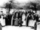 <p>Identifications of some individuals in photo on page 74. Double wedding of Stolanus Arnold and Magdalena and Stolanus' sister, Monica, Arnold and Michael Ternes.<br />
1. Monica Arnold, born 1891, Kararaurat, Dobrudscha, Romania, bride to Michael Ternes, #2.<br />
2. Michael Ternes, born 1887, Karamurat, died Houpststy, München, Germany, parents:  Anton and Elisabetha (Müller) Ternes.<br />
3. Kasimir Ternes, uncle to groom #2, born 1856, Krasna, Bessarabia, Russia, died 1943, Kronau, Moravia, Czechoslovakia, parents: Michael and Elisabetha (Fähnrich) Ternes.<br />
4. Eva (Aspeleiter) Haag, wife of Anton Haag, #15, born 1885, Malcoci, Dobrudscha, Romania, died 1979, Werne, Germany, daughter of Nikolaus Aspeleiter.<br />
5. Josef Ternes, brother to groom #2, born 1882, Karamurat, died 1945, Szonok, Hungary,son of Anton and Elisabeth (Müller) Ternes.<br />
6. Anton Ternes, father of groom #2, born 1850, Krasna, died 1925, Karamurat, parents:  Michael and Elisabetha (Fähnrich) Ternes.<br />
7. Elisabetha (Muller) Ternes, mother of groom #2, born 1857, Krasna, died 1933, Karamurat, parents:  Mathias and Johanna (Wuitschik) Müller.<br />
8. Regina Ternes, sister of groom #2, born 1894, Karamurat, died 1928, Karamurat, married Josef Woitowitsch.<br />
9. Peter Ternes, brother of groom #2, born 1875, Krasna, died 1978, Estevan, SK, Canada, married Veronica Bachmeier, #10.<br />
10. Veronica (Bachmeier) Ternes, wife of #9, born 1882, Krasna, died 1967, Estevan, parents:  Johannes and Marianna (Lauterbach) Bachmeier.<br />
11. Stolanus Arnold, groom to #12, born 1890, Karamurat, died 1940, Blumenfeld, SK, Canada, parents:  Anton and Otilia (Seifert) Arnold.<br />
12. Magdalena Haag, bride to #11, born about 1892, Colelia, Dobrudscha, Romania, died 1950, Canada, parents:  Timotheus and Franziska (Heintz) Haag.<br />
13. Anton Arnold, father of groom #11, born 1865, Krasna, died 1919, Karamurat, husband of Otilia Seifert, #13, parents: Johannes and Katharina (Bogolowski) Arnold.<br />
14. Ottilia (Seifert) Arnold, mother of groom #11, wife of Anton Arnold, #13, born 1869, Krasna, parents: Johannes and Magdalena (Ziebart) Seifert.<br />
15. Anton Haag, brother of bride #12, born 1879, Kandel, Odessa, Ukraine, died 1940, Schweinfurt, Bavaria, Germany.<br />
16. Anna Maria (Arnold) Götz/Getz Hoffart, sister to Anton Arnold, #13, born 1869, Krasna, died 1940, Karamurat, married 1) Nikolaus Götz/Getz and 2) Joachim Hoffart <br />
17 or 21. Apollonia (Arnold) Plotzki, sister to Anton Arnold, #13, born 1873, Krasna, died 1950, Barbing, Bavaria, Germany, married Jakob Plotzki, #24.<br />
18.        Veronica (Arnold) Fähnrich, sister to Anton Arnold, #13, married Anton Fähnrich.<br />
19.        Isidor Both, born 1874, Krasna, died 1939, Gross Pallas, Dobrudscha, Romania, parents: Friedrich and Elisabeth (Plotzky) Both.<br />
20.        Timotheus Haag, father of bride #12, born 1851, Krasna, died 1930, Prelate, SK, Canada, son of Michael and Hedwig (Klötzel) Haag.<br />
22.        Rosina (Arnold) Fähnrich, sister to Anton Arnold, #13, bom 1862, Krasna, died 1938, Karamurat, married Anton Fähnrich.<br />
23.        Peter Ternes, brother to groom #2, born 1875, Krasna, died 1978, Estevan, married Veronica Bachmeier, #<br />
24.        Jakob Plotzki, husband of #17 or 21, born 1863, Krasna, died 1951, Barbing, parents: Peter and Julianna (Ihli) Plotzky.<br />
Source: Sister Callista Arnold<br />
▶  https://www.krasna-photo-collection.de/_detail/bilder/2/apk-124x/124x_page-074-b.jpg<br />
 <br />
Problem  #18:<br />
Veronica (Arnold) Fähnrich, sister to Anton Arnold, #13, married Anton Fähnrich.<br />
There is no Veronica Arnold in KPC and no Veronica married to Fähnrich. Anton has no sister named Veronica.<br />
Based on bride *1891 and groom *1887, number 18 is older.<br />
Presumably:<br />
Rosina (Arnold) Fähnrich, sister to Anton Arnold, #13, married Anton Fähnrich. (I8066 ) ? #22</p><p>Fähnrich, Ternes, Both, Haag, Müller, Hoffart, Plotzki, Seifert, Arnold, Aspeleiter, Woitowitsch, Getz-Götz</p><p>124x_page-074.jpg</p><p><a href="/_detail/alles/apk-1a/124x_page-074.jpg"><img title="Details" src="/lib/plugins/photogallery/images/details_page.png" width="30" /></a></p>